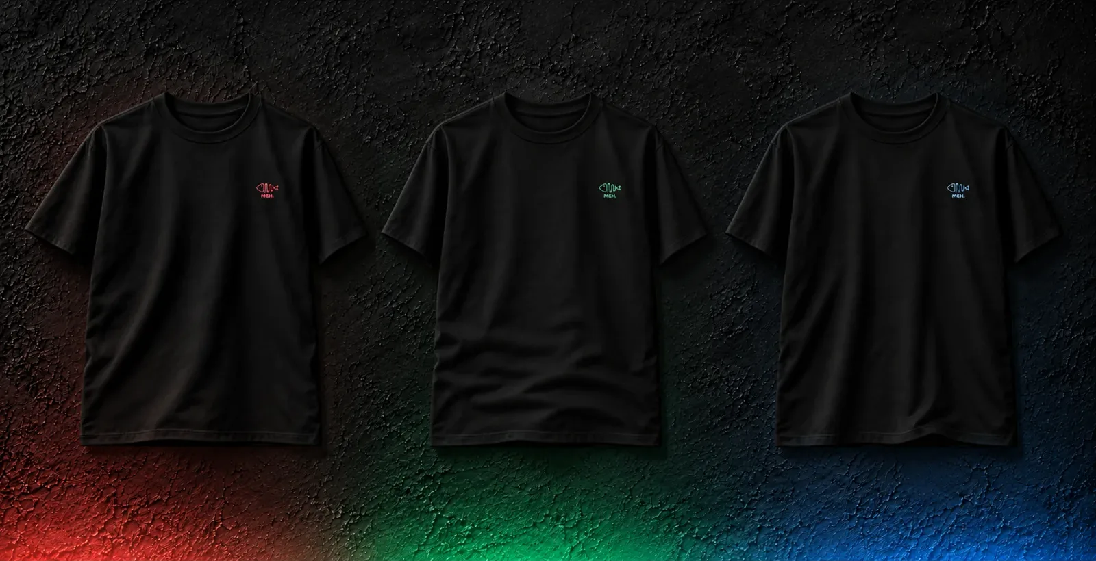 Tres camisetas negras MEH. con el logo en coral, verde y azul